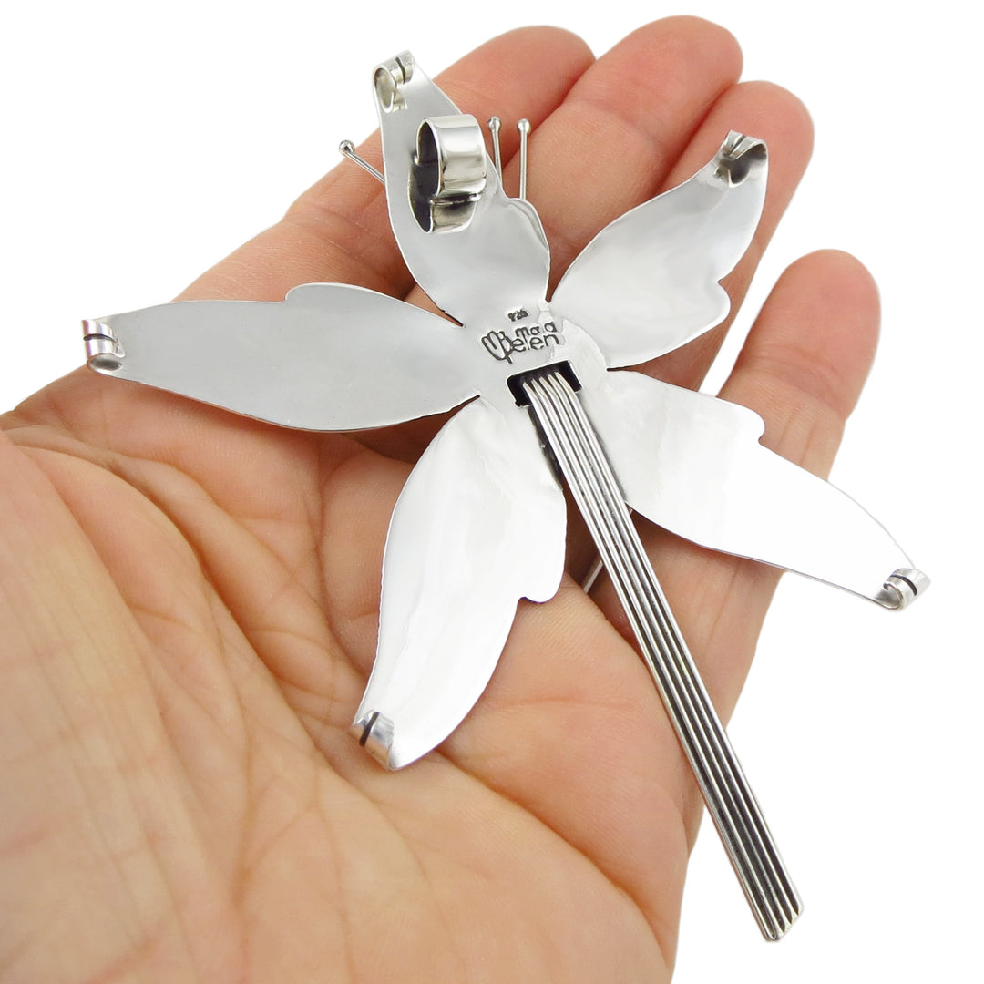 The reverse of a large silver orchid flower pendant hallmarked 925 Maria Belen 