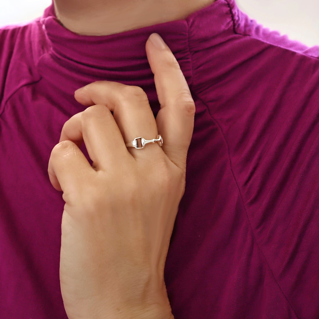 Woman in a purple top wearing an equestrian design solid 925 silver horse snaffle design ring