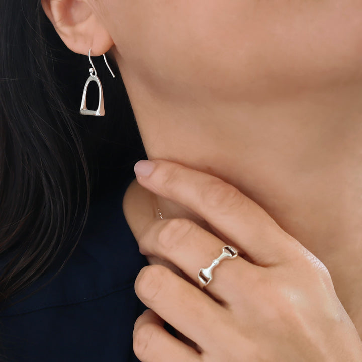 Woman wearing a horse snaffle earring and snafflebit ring in UK sterling 925 silver