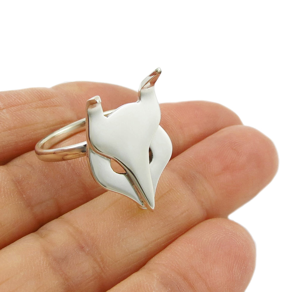 A large polished 925 sterling silver sculpted ring for women in the shape of a fox head held in a hand