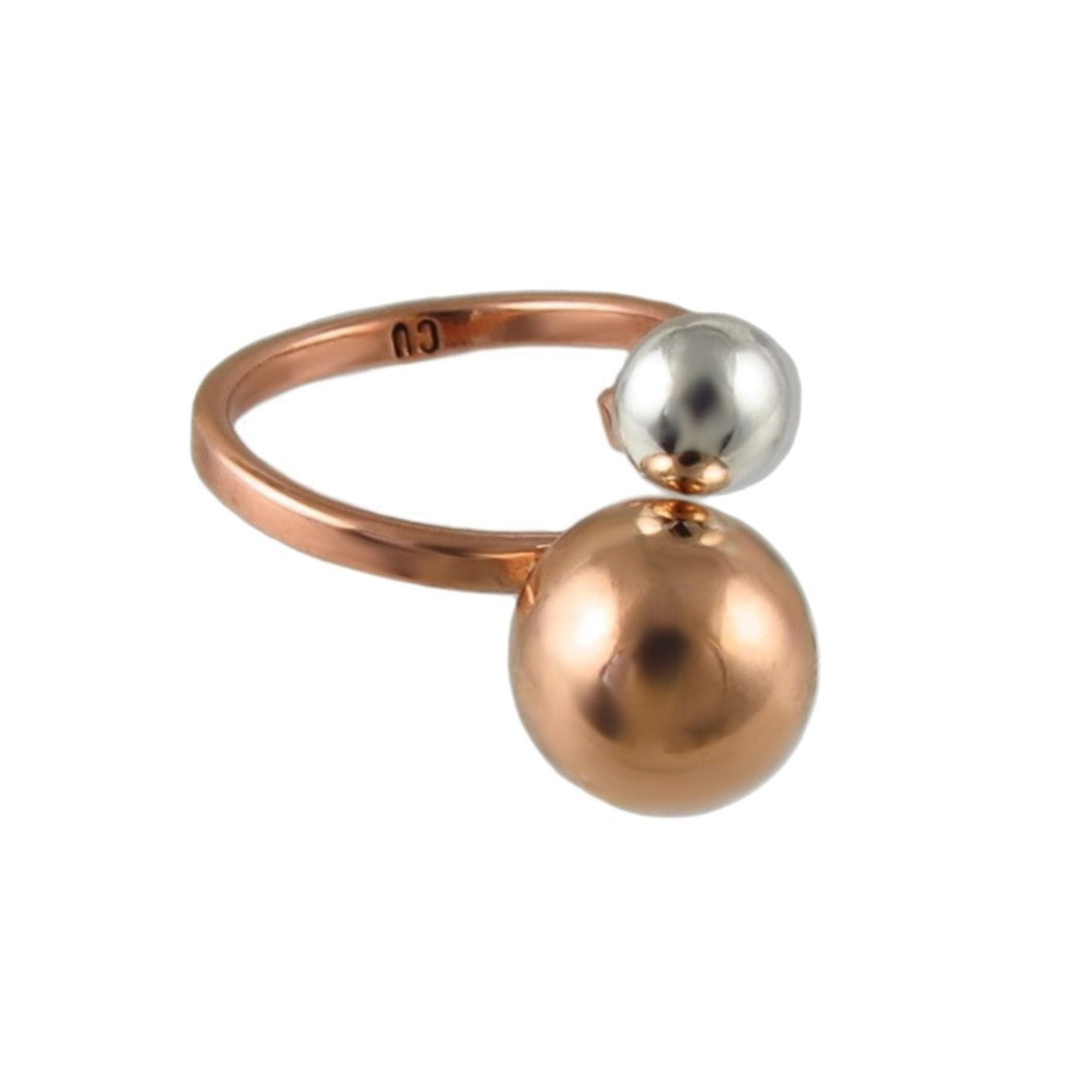 Ring with two spherical beads, one copper and one silver, on a white background.