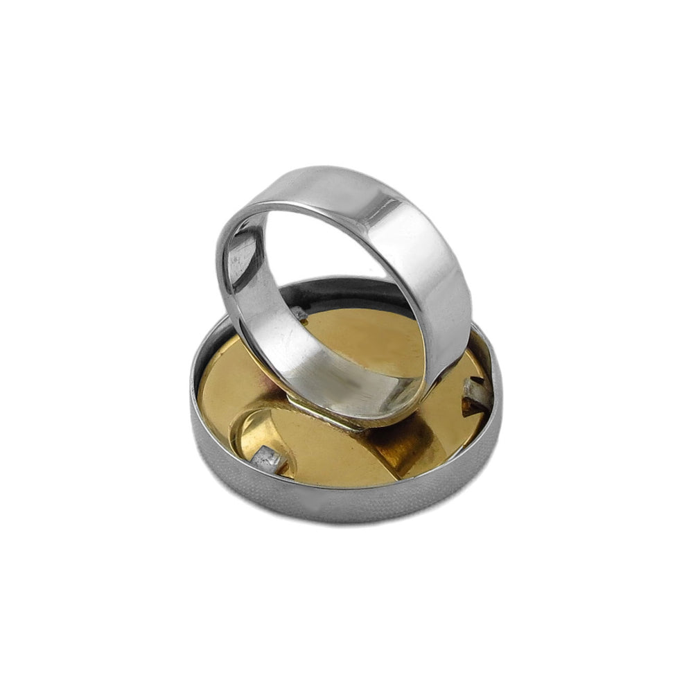 Revere of a large 925 silver and gold cocktail ring on a white background. 