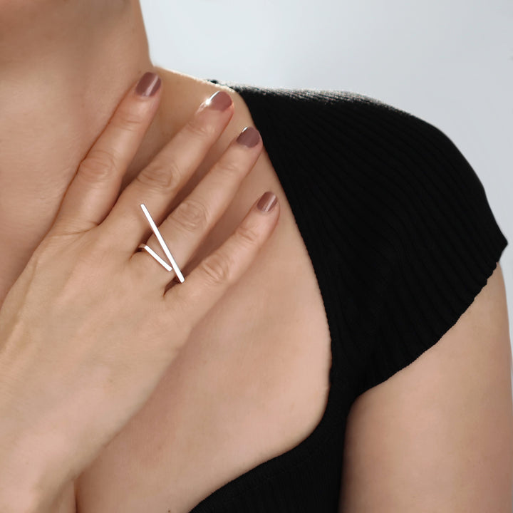 A woman wearing a modern dress ring in silver