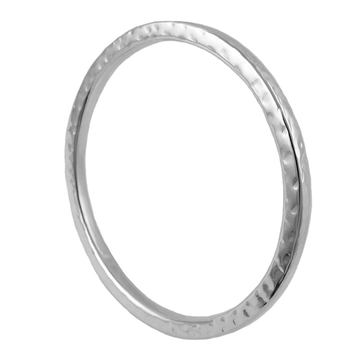 Large hammered silver bangle on a white background