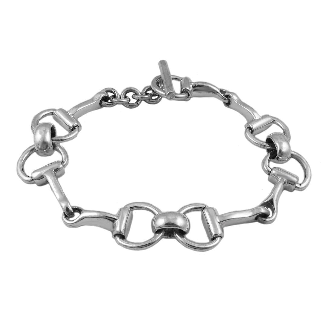 A sterling silver bracelet designed in the shape of a horsebit snaffle, with a secure t-bar toggle fastener.