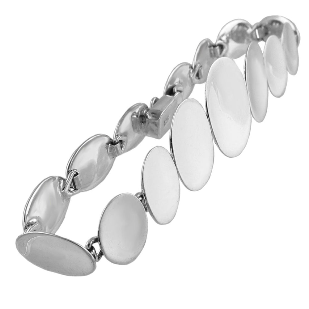 A silver bracelet with a series of oval links, reflecting light around the wrist.