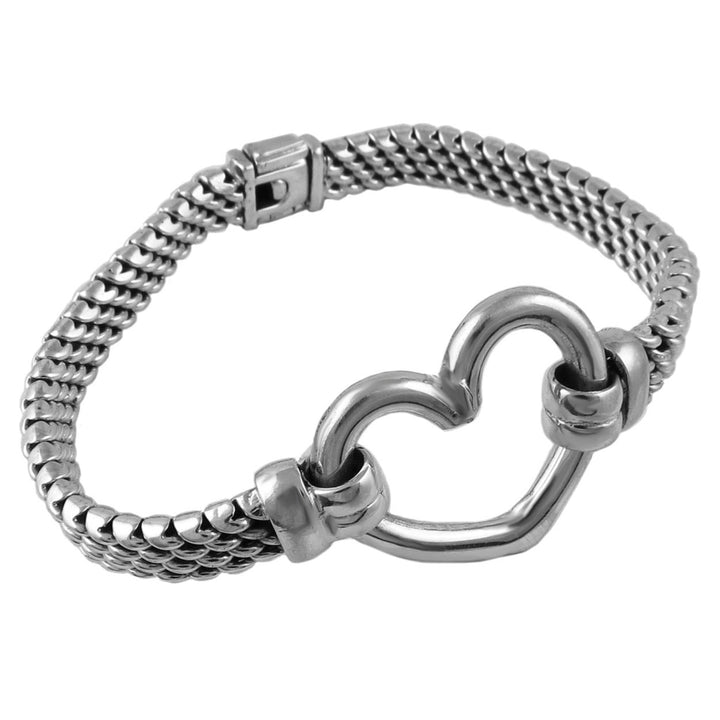 Silver chunky chain bracelet with a unique heart accent on a white background