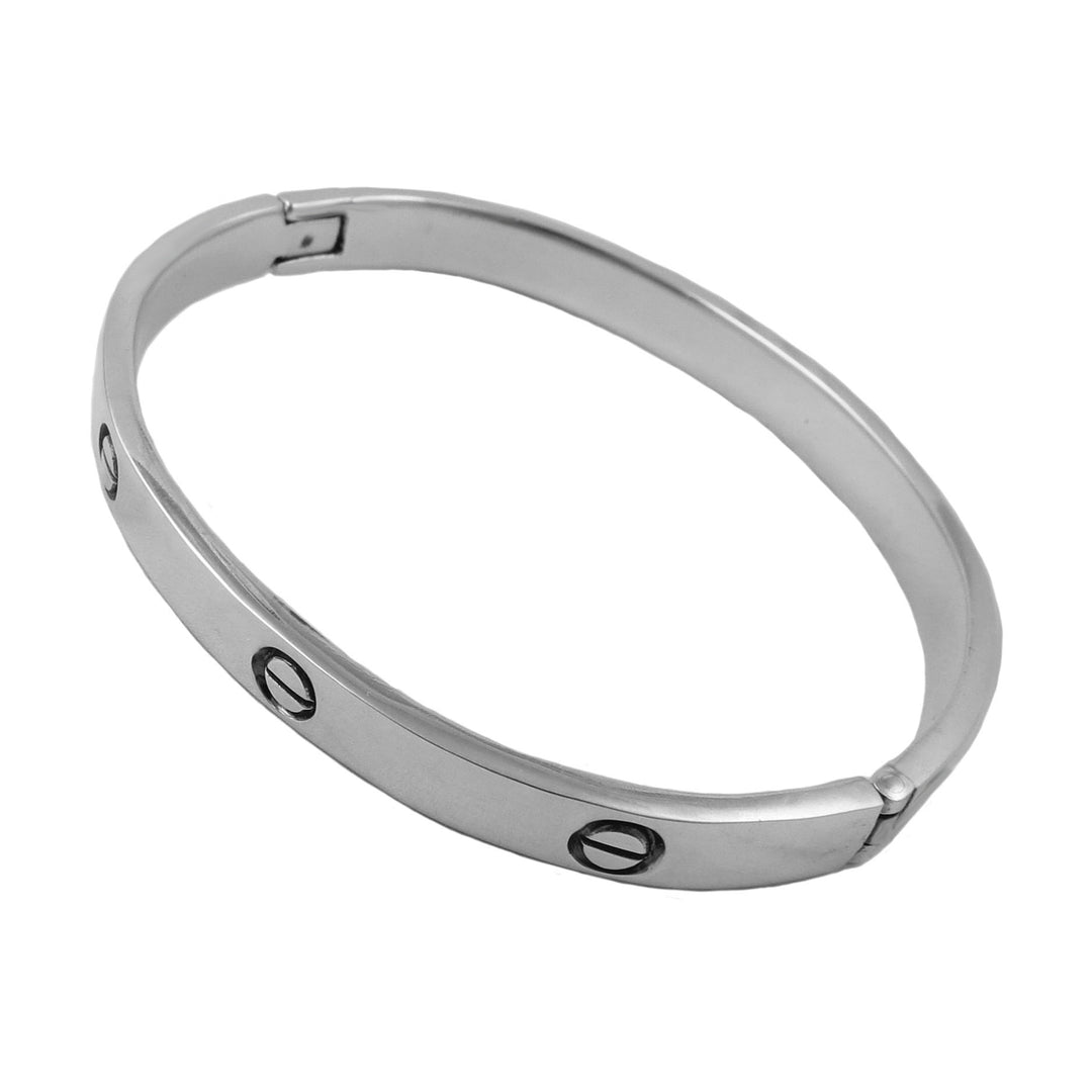 Silver bracelet with engraved rivet screw outlines on a white background