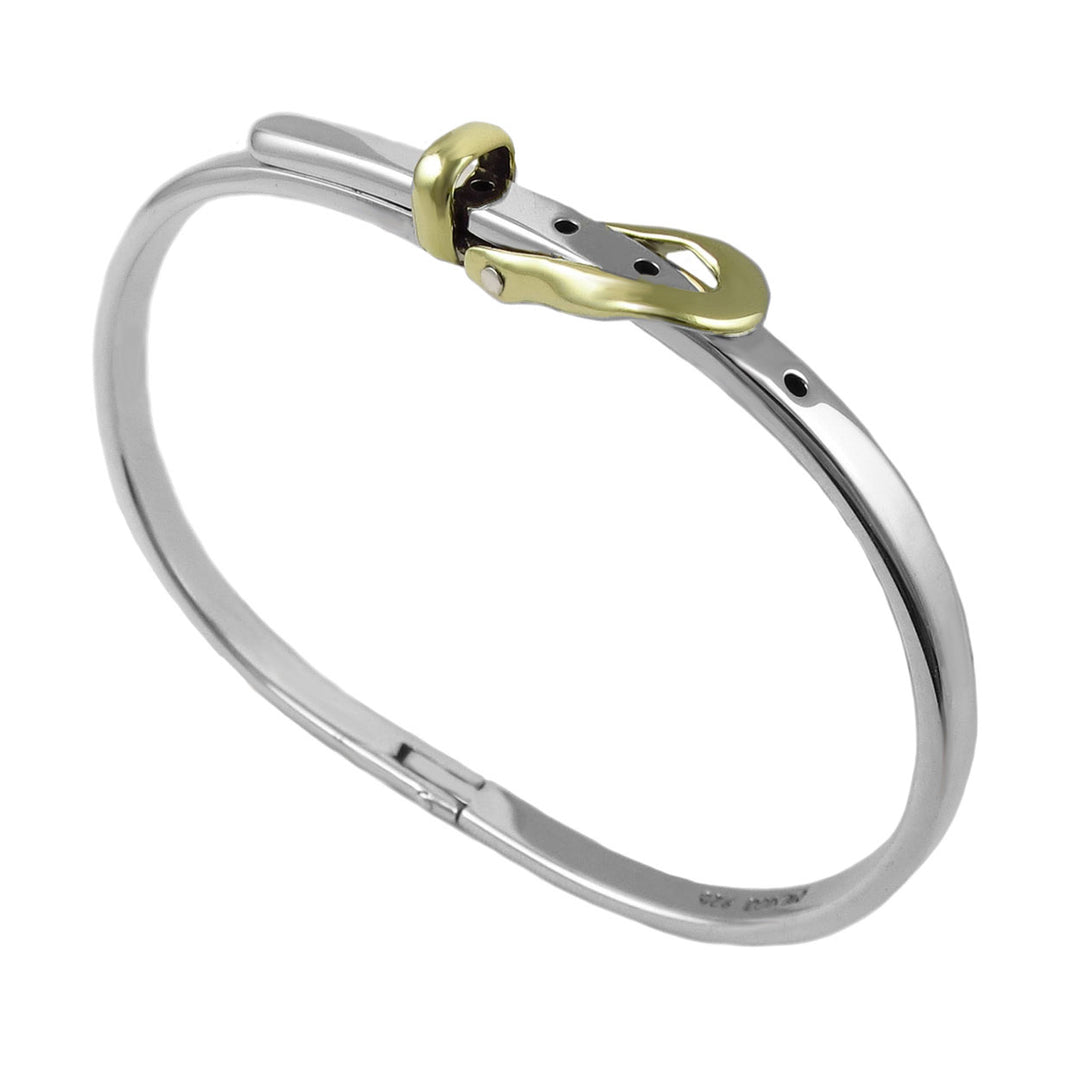Silver buckle design bracelet with gold accents on a white background