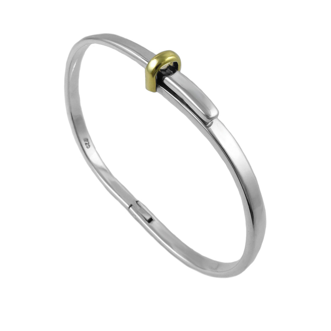 Silver bangle with a gold accent on a white background