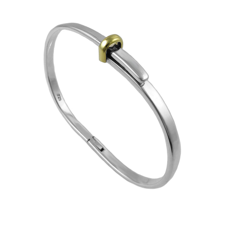 Silver bangle with a gold accent on a white background