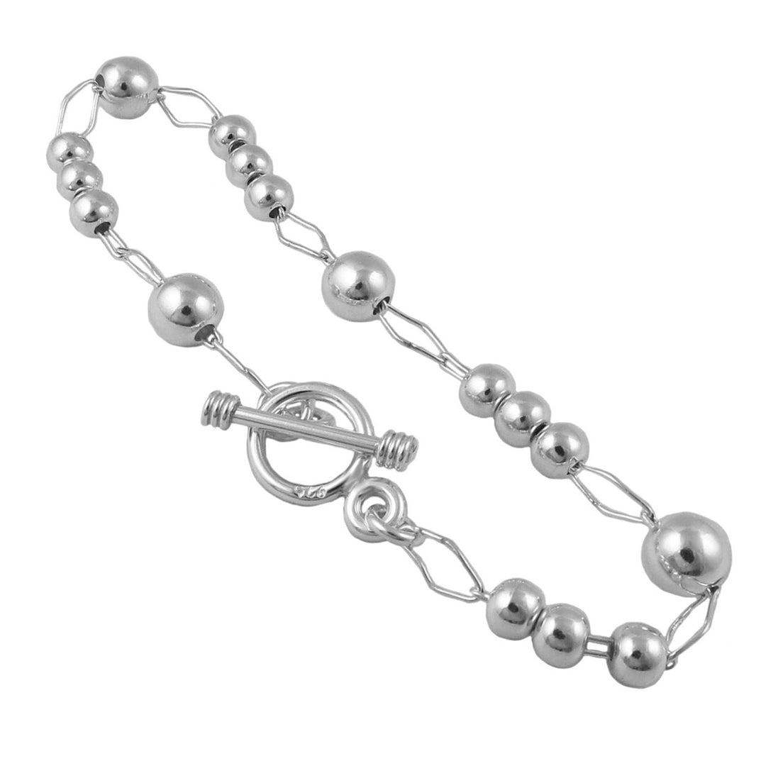 UK sterling silver bracelet featuring unusual chain and ball beads in an pen and closed link pattern on a white background