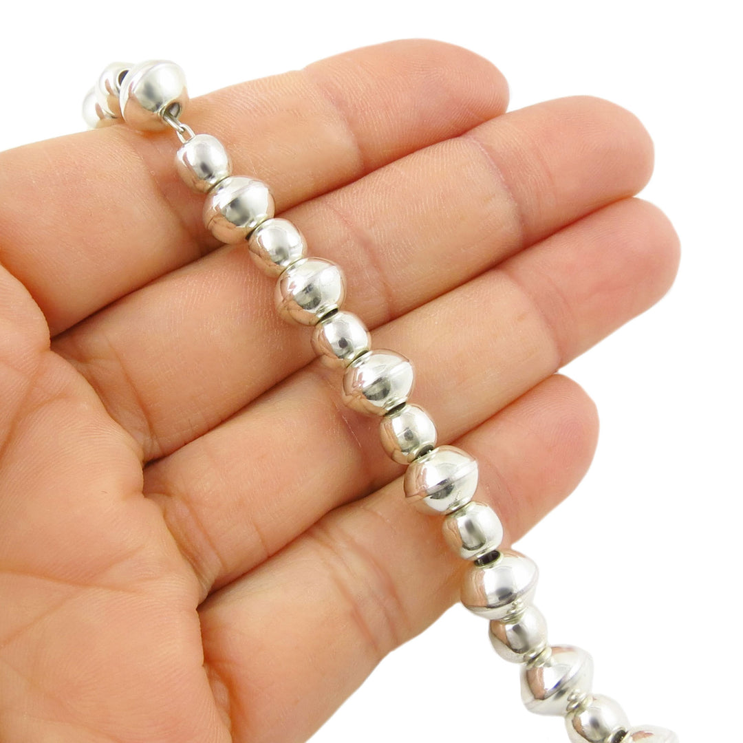 UK 925 sterling Silver beaded polished bracelet on a hand with a white background