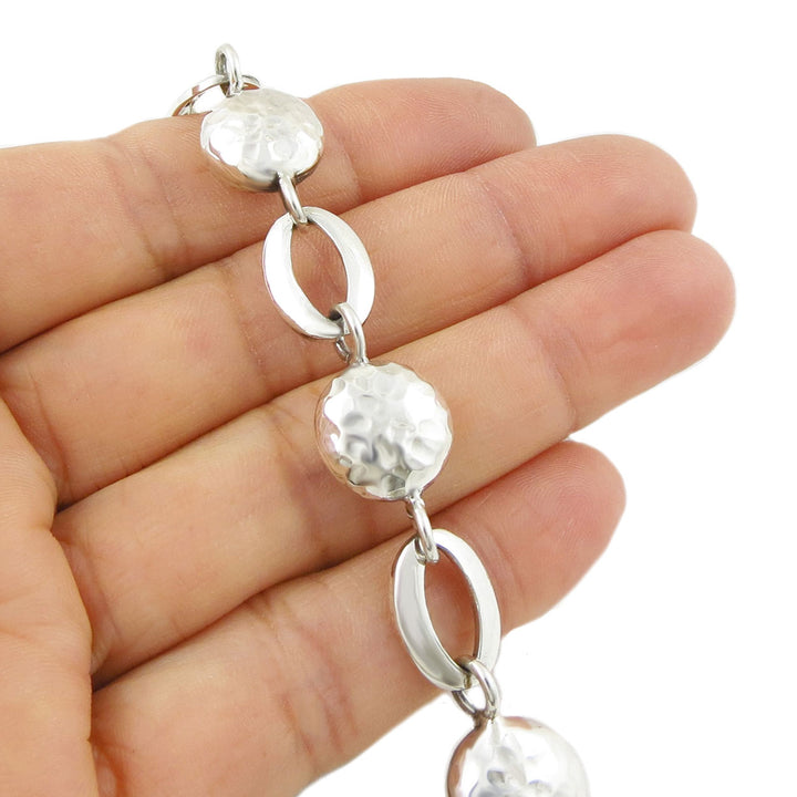 Handmade 925 sterling Silver bracelet with round and oval links held by a hand on a white background