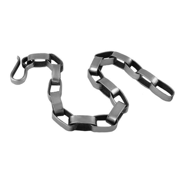 UK sterling silver modern oval link chain bracelet with an industrial brutalist finish on a white background