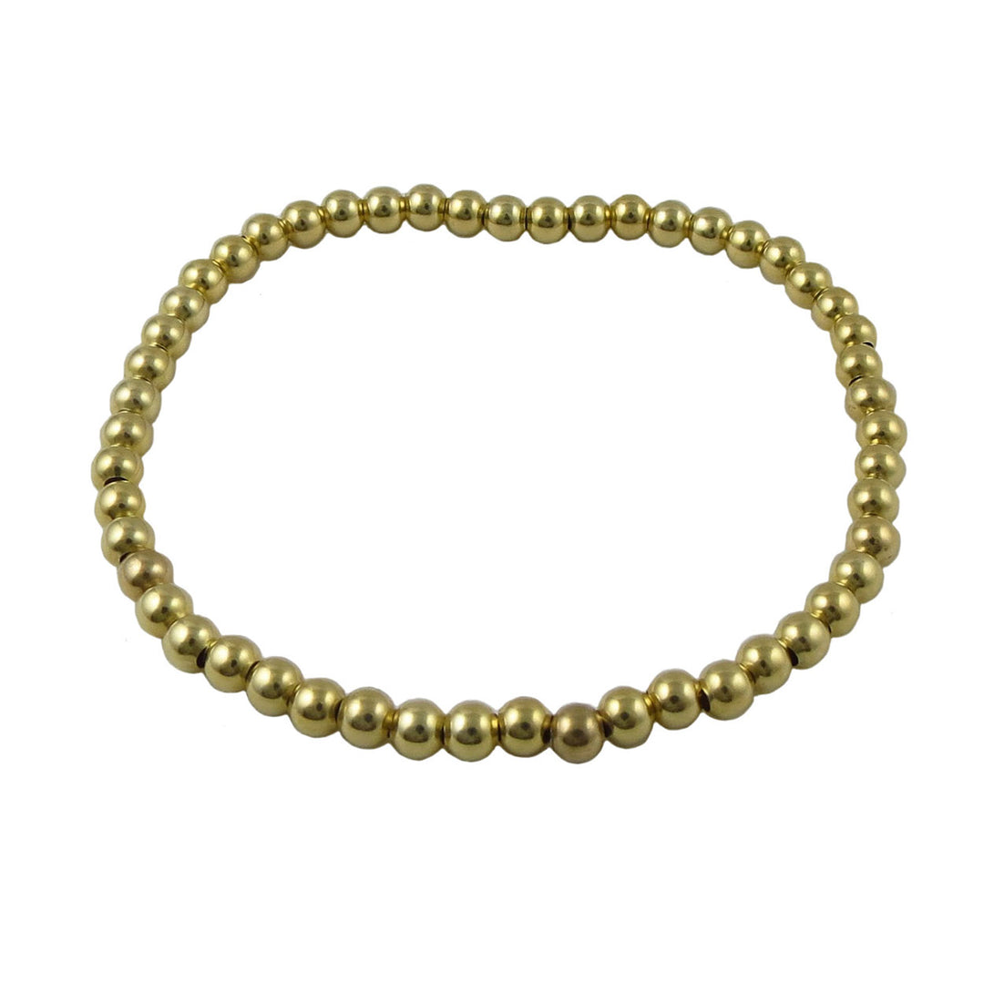 Gold beaded bracelet on a white background