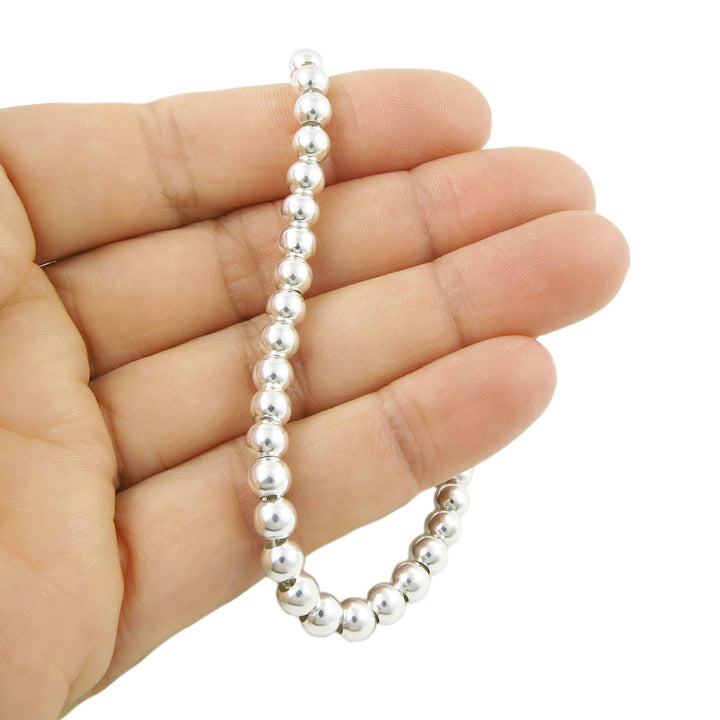 925 sterling silver beaded bracelet on a hand against a white background