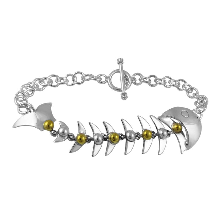 Mexican sterling 925 silver and gold large fish skeletone bracelet with a t-bar toggle on a white background