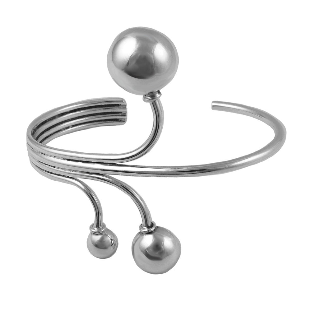 Silver bracelet with spherical ends on a white background