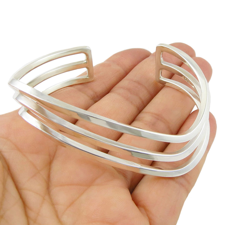 sterling silver bracelet UK held in a hand against a white background