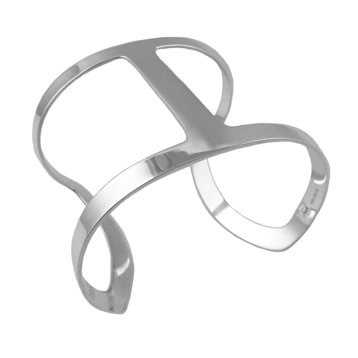 Artisan sterling silver cuff style bracelet with a unique design on a white background