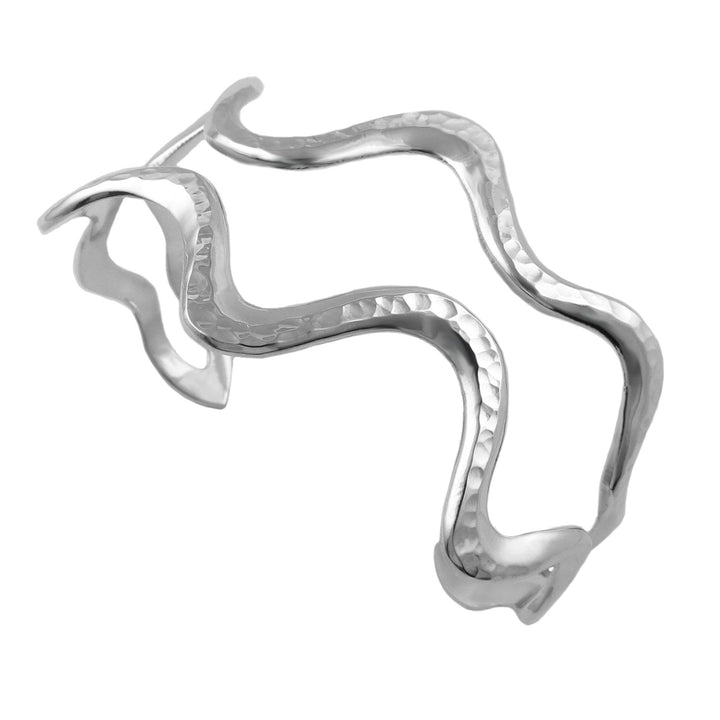 Handmade sculpted sterling silver cuff bracelet on a white background