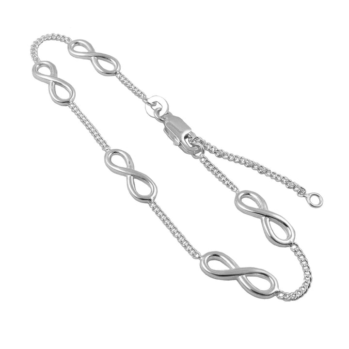 A sterling 925 silver chain bracelet with a lobster cla fastener featuring a curb chain decorated with figure of eight infinity links with an extension chain to change the length