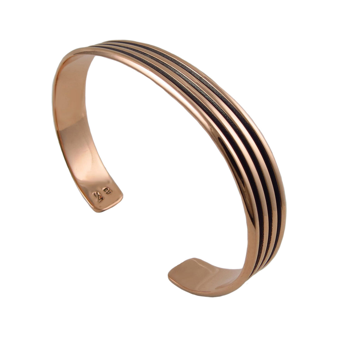 Women's solid copper bracelet with black stripes on a white background