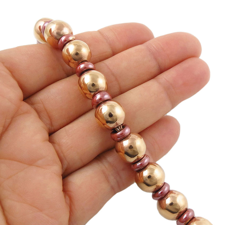 Copper ball bead bracelet for women on a hand with a white background