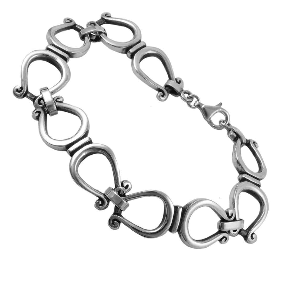 A UK hallmarked sterling 925 silver bracelet composed of interlocking horseshoe shaped links with decorative scroll details, shown on a plain white background.