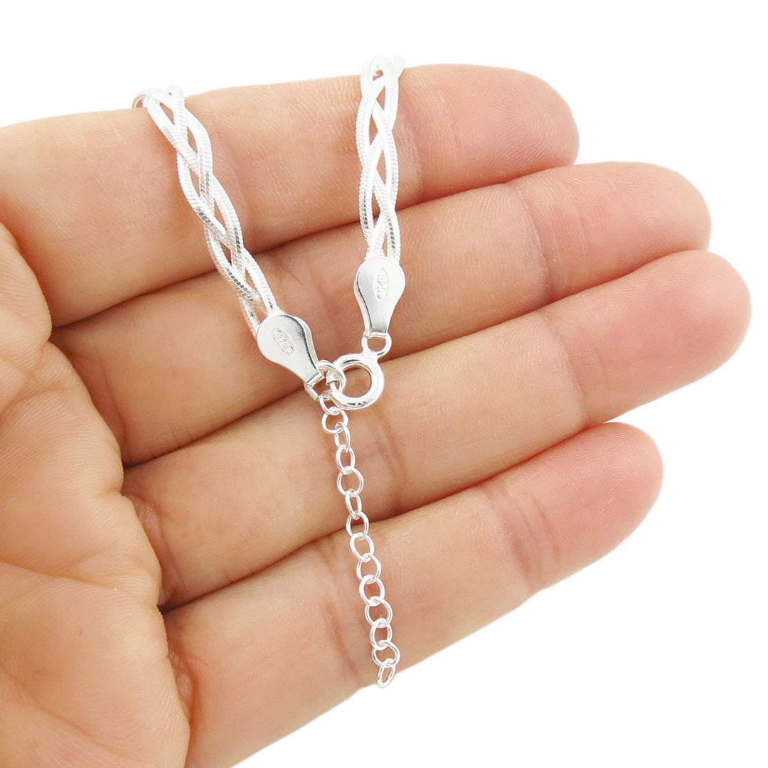 UK hallmarked 925 sterling Silver braided snake chain necklace clasp showing an adjustable extension chain held between fingers on a white background
