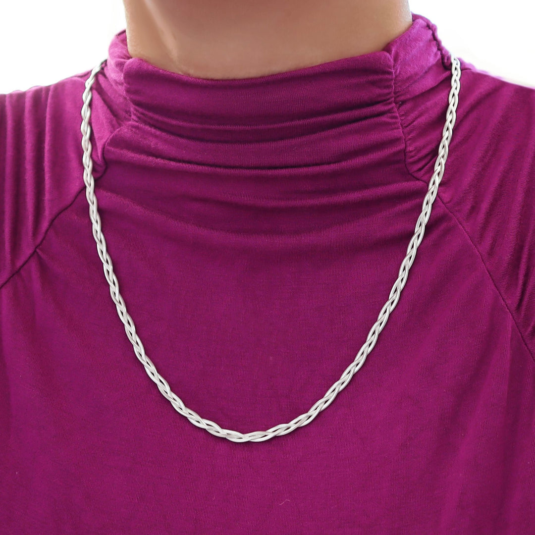 A braided 925 sterling silver three in one snasnake chain necklace worn by a woman in a purple top