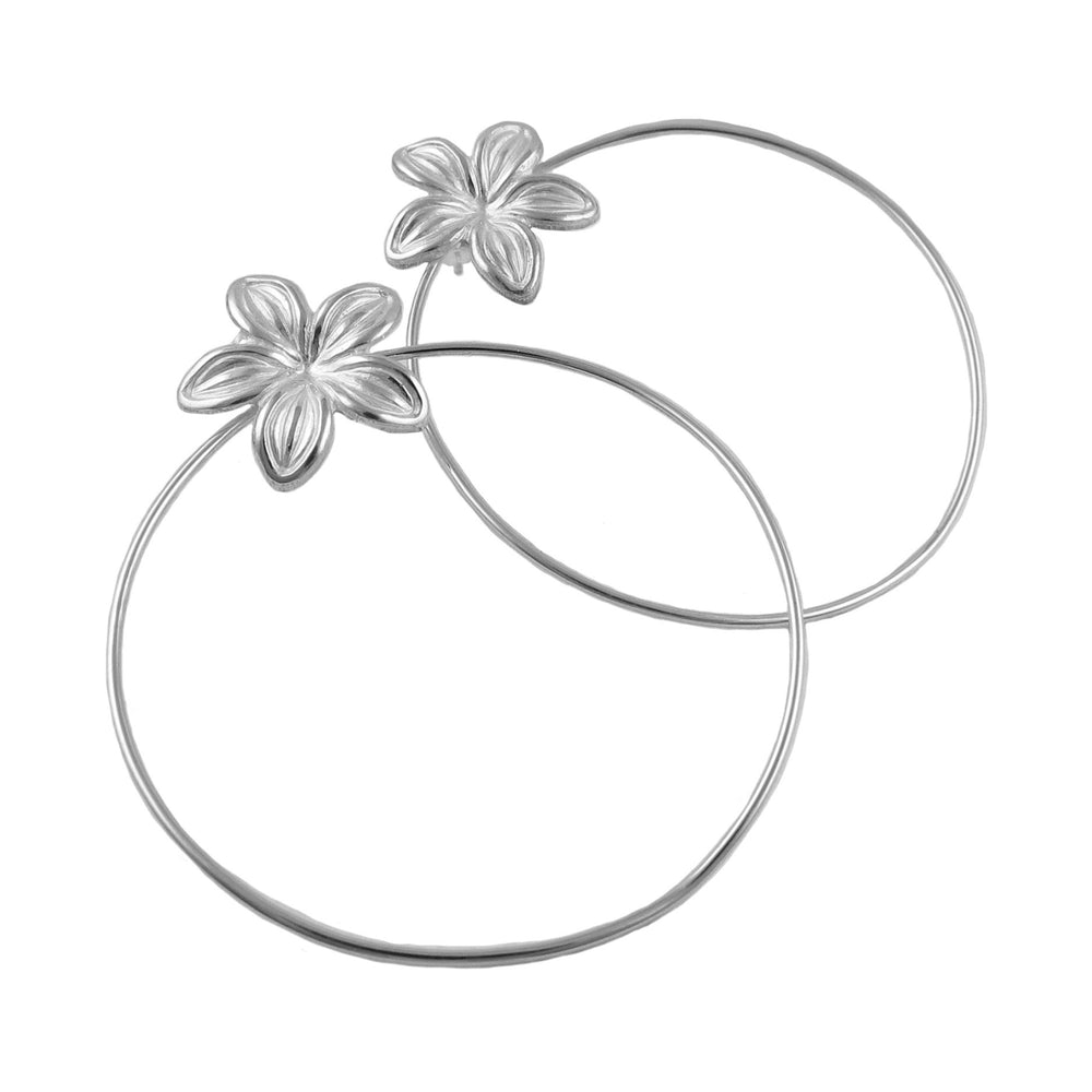 A pair of handmade Mexican 925 sterling silver hoop earrings with a floral pattern, showing an open-petal flower attached to each hoop on  white background. 
