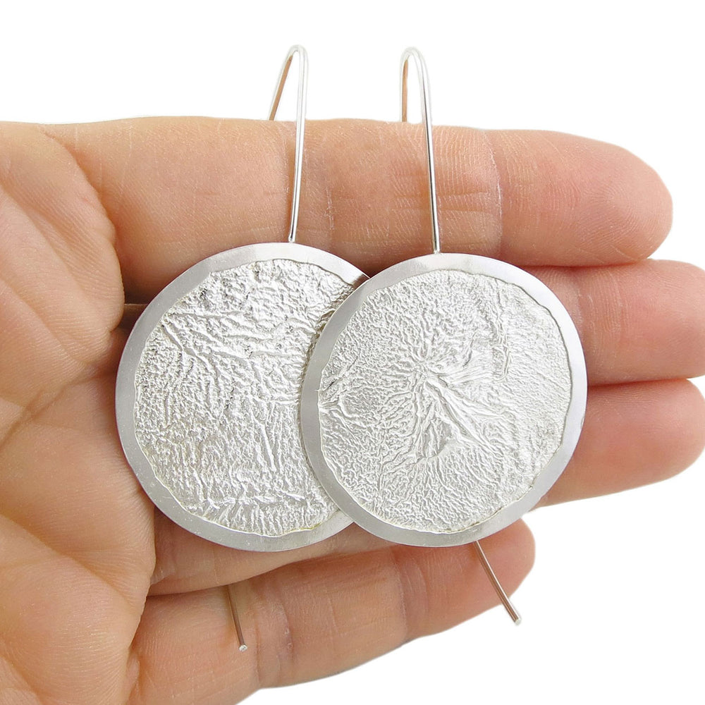 Large Maria Belen Nilson Mexican 925 silver reticulated circle disc threader earrings held in a woman's hand