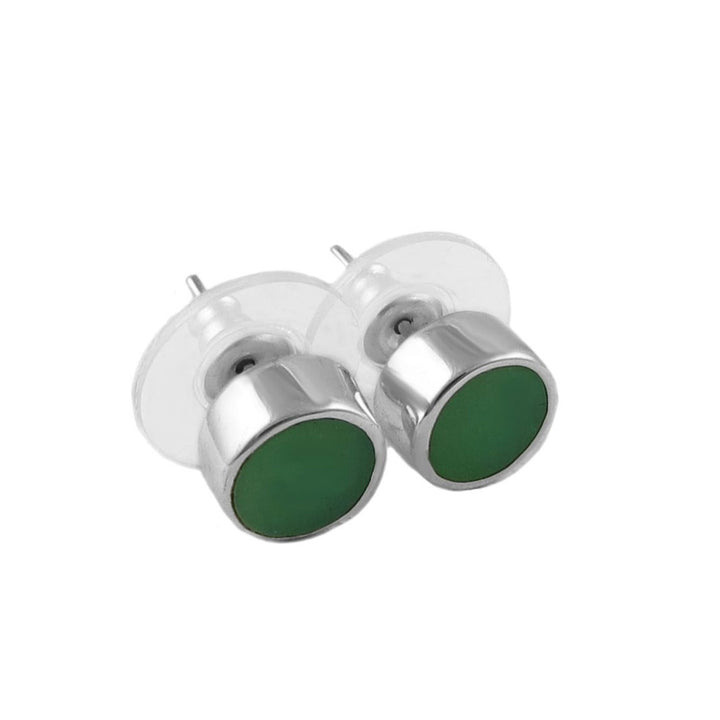 Silver earrings with green round stones on a white background