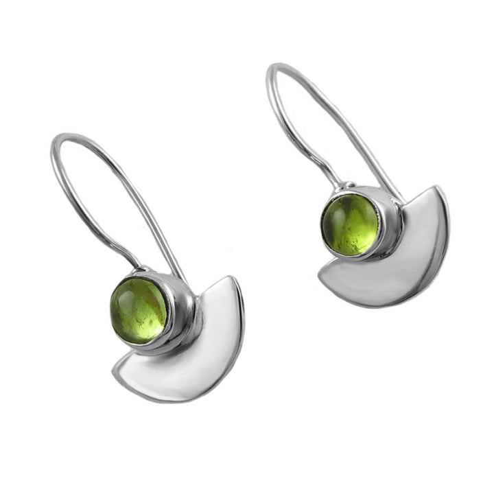 Silver earrings with green peridot gemstones on a white background