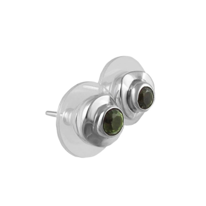 Silver earrings with green peridot gemstones on a white background