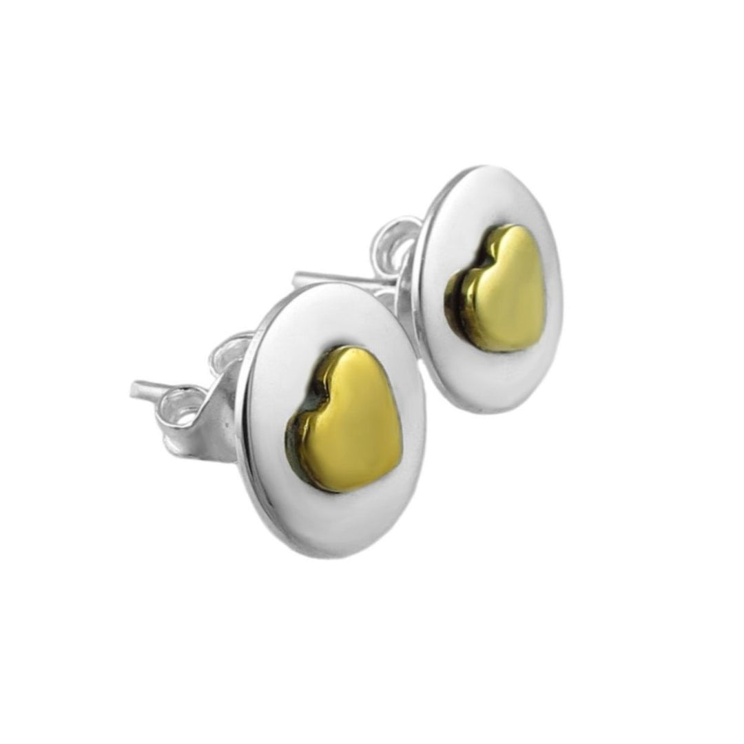 Pair of silver earrings with gold heart centers on a white background