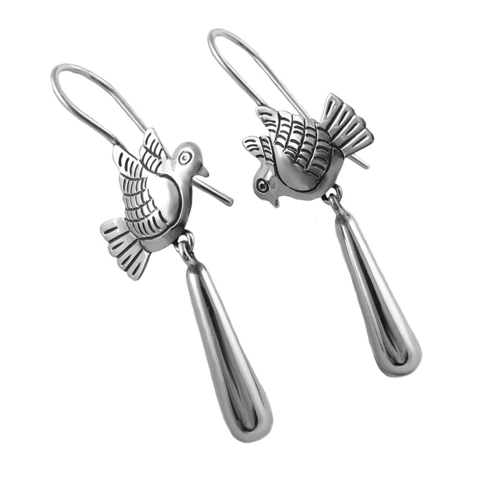 Silver dove-shaped earrings on a white background