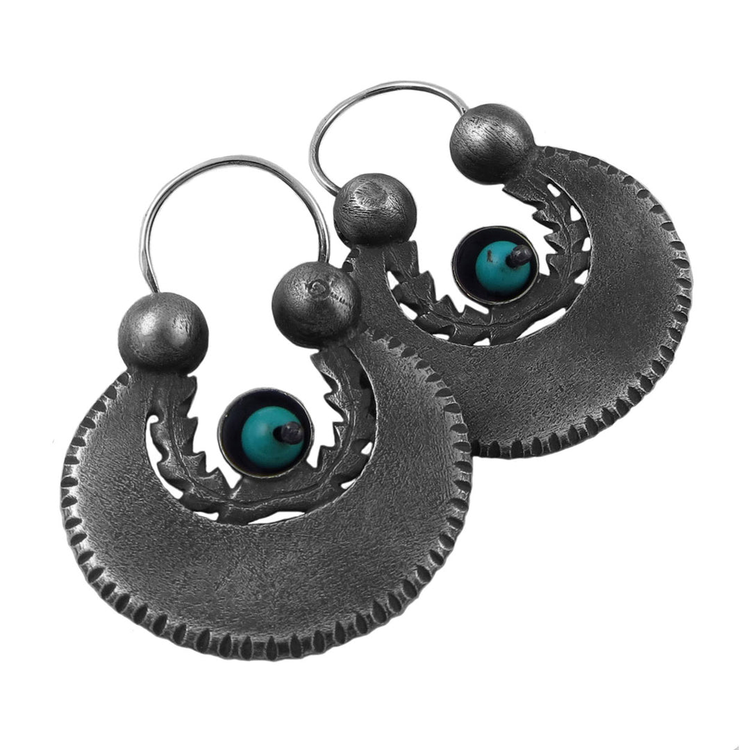 Pair of blackened 925 sterling silver earrings with natural turquoise gemstones on a white background