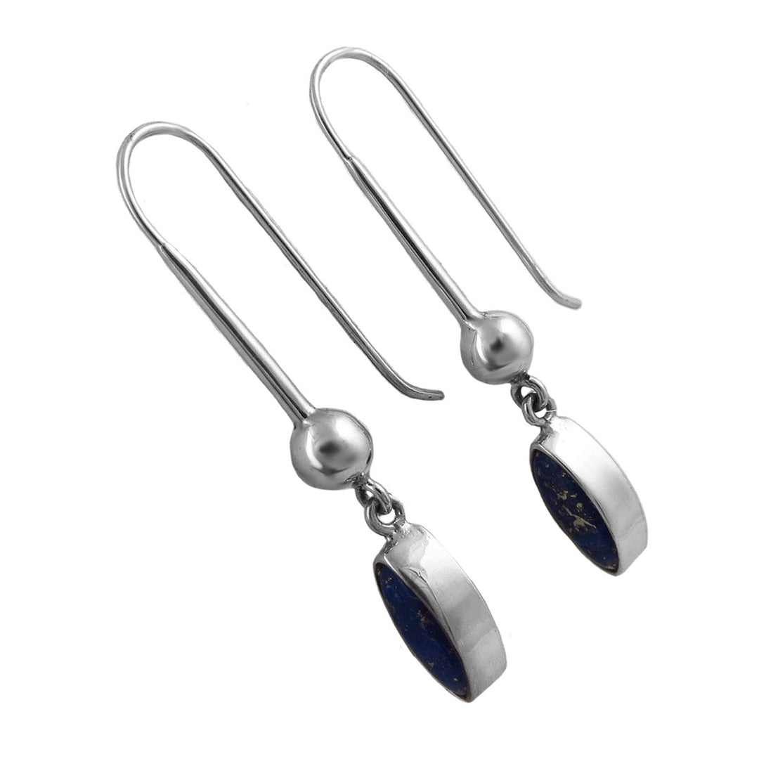 Long silver drop earrings with blue lapis lazuli gemstones on a white background. 