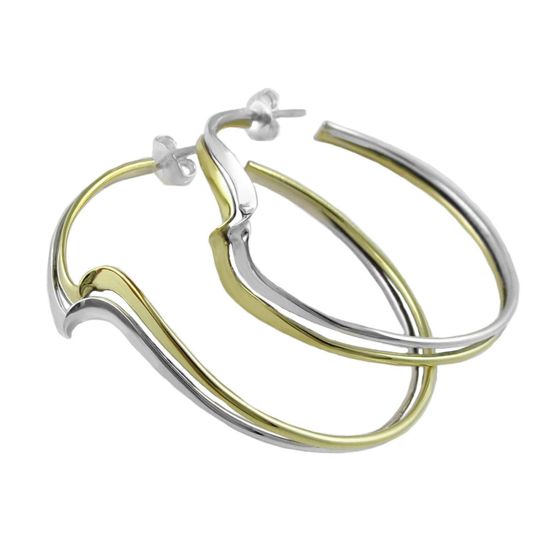 Gold and silver curved hoop earrings on a white background. 