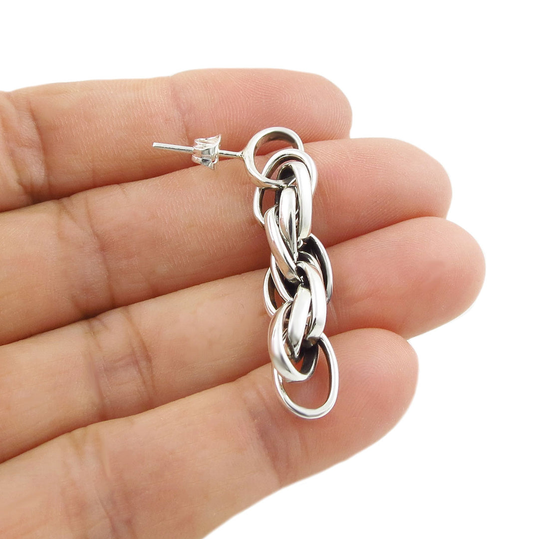 A single 925 silver drop earring featuring a rope chain design and a post and butterfly fastener held in a person's hand