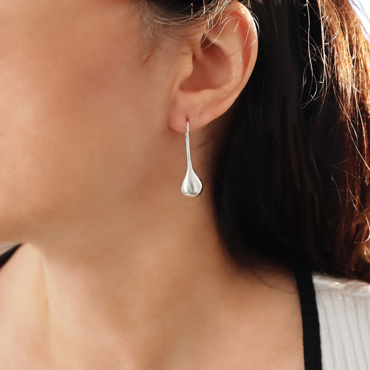 925 sterling silver teardrop earring worn by a woman with dark hair.