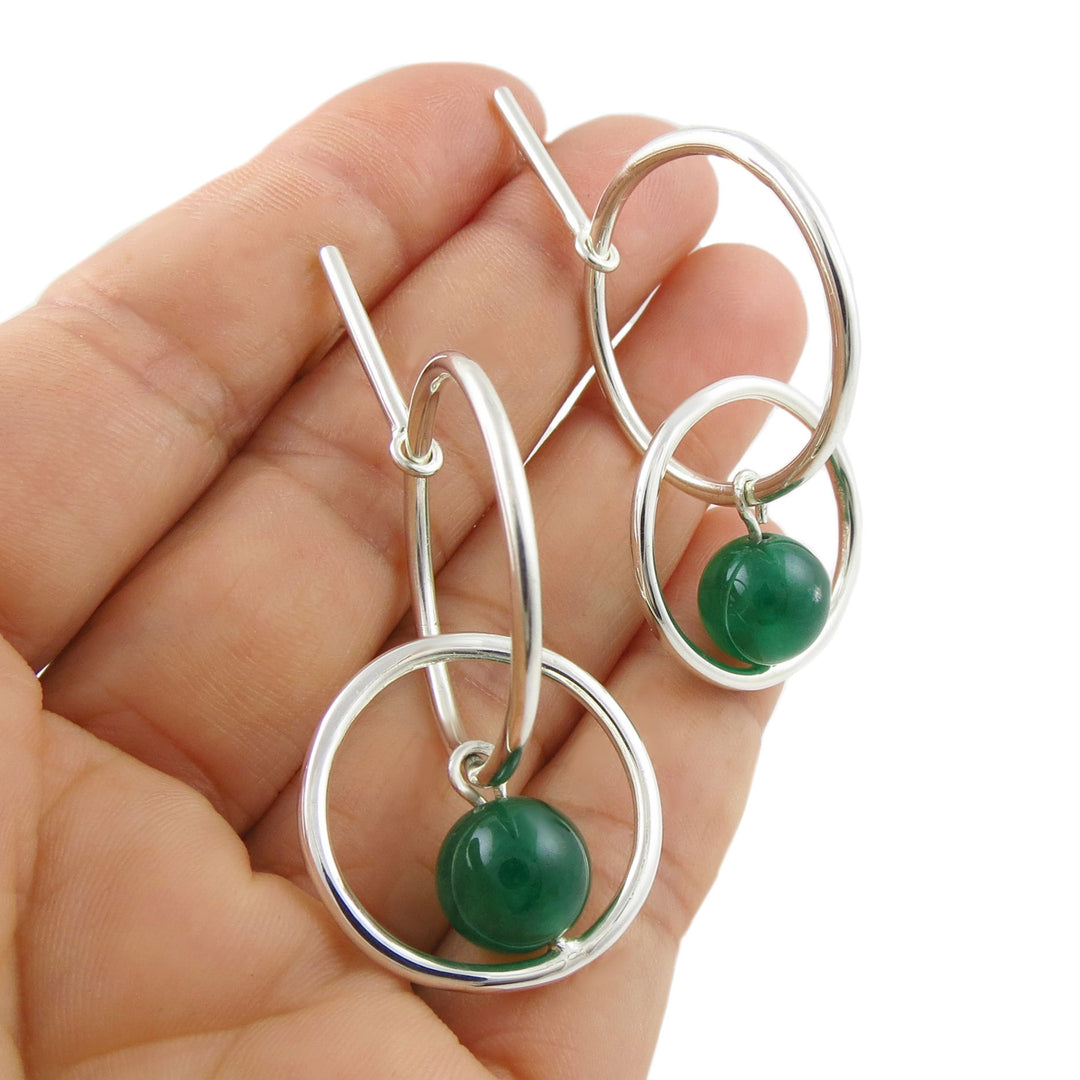 Handmade sterling 925 silver drop earrings with green aventurine gemstone beads held in a hand against a white background