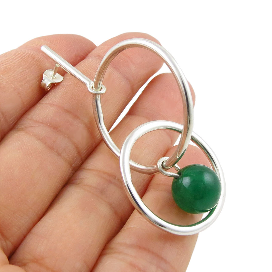 925 silver hoop earrings with a green aventurine gemstone beads held in a hand on a white background