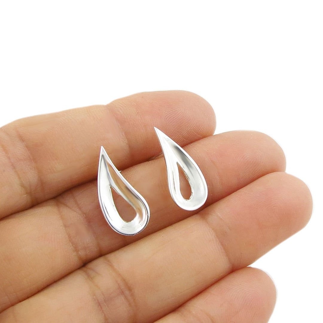 Polished 925 sterling silver teardrop-shaped earrings with a tapered edge held between fingers on a white background