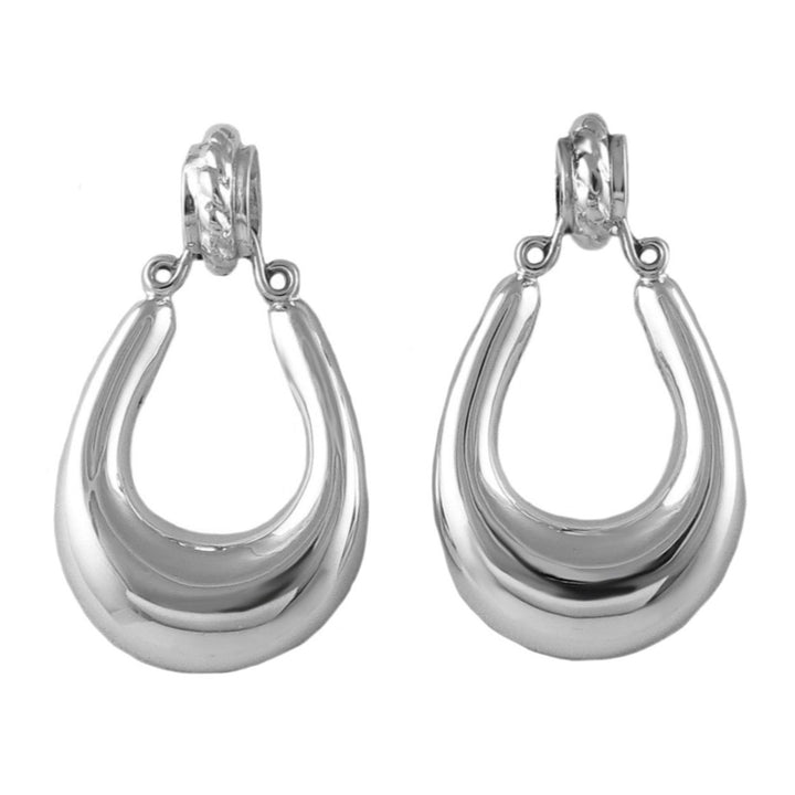 Pair of large handmade Mexican 925 sterling silver gypsy hoop earrings on a white background