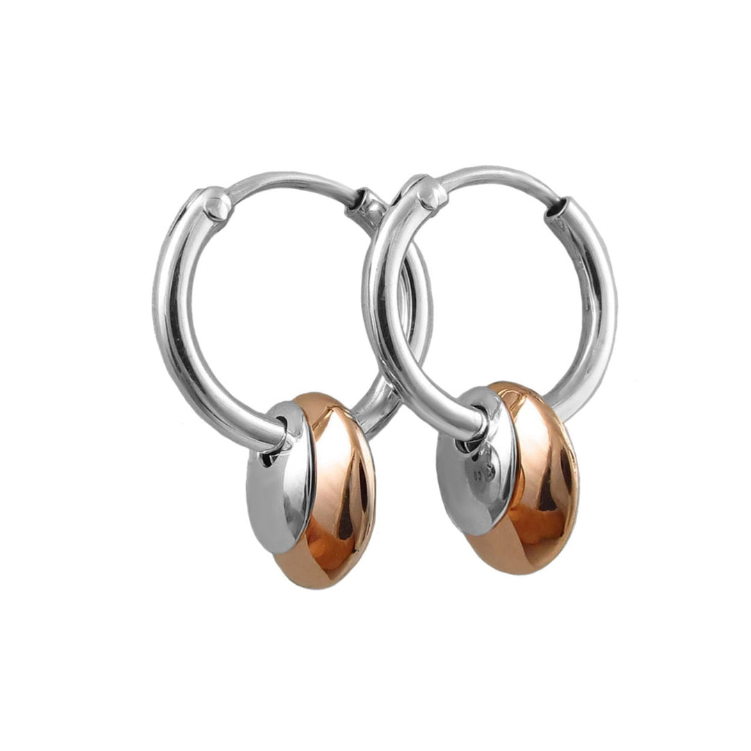 A pair of mixed metal 925 silver and copper hoop earrings with a dual-tone oval drop charm featuring polished silver and copper disc halves, set against a plain white background.