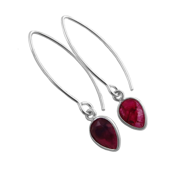 A pair of silver drop earrings with teardrop-shaped deep pink and red faceted ruby quartz gemstones, shown on a plain white background.